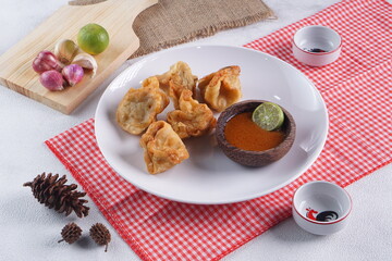 batagor,is a street food that is very popular in Indonesia.made from fish, tapioca and seasoning wrapped in dumplings then fried. Served with spicy peanut sauce. photographed with studio light