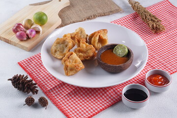 batagor,is a street food that is very popular in Indonesia.made from fish, tapioca and seasoning wrapped in dumplings then fried. Served with spicy peanut sauce. photographed with studio light