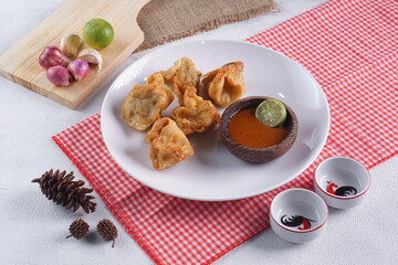 batagor,is a street food that is very popular in Indonesia.made from fish, tapioca and seasoning wrapped in dumplings then fried. Served with spicy peanut sauce. photographed with studio light