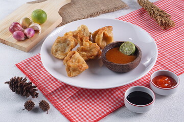 batagor,is a street food that is very popular in Indonesia.made from fish, tapioca and seasoning wrapped in dumplings then fried. Served with spicy peanut sauce. photographed with studio light