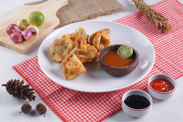 batagor,is a street food that is very popular in Indonesia.made from fish, tapioca and seasoning wrapped in dumplings then fried. Served with spicy peanut sauce. photographed with studio light