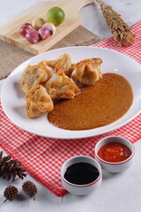 batagor,is a street food that is very popular in Indonesia.made from fish, tapioca and seasoning wrapped in dumplings then fried. Served with spicy peanut sauce. photographed with studio light