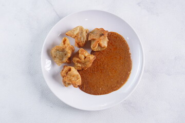 batagor,is a street food that is very popular in Indonesia.made from fish, tapioca and seasoning wrapped in dumplings then fried. Served with spicy peanut sauce. photographed with studio light