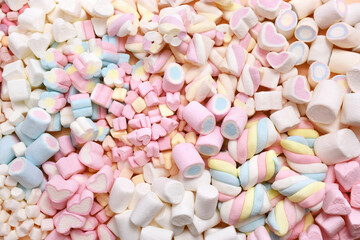 Confectionery and sweeties varieties background: light pink and white marshmallows, sugar confetti, bonbon and candies, selective focus, shallow focus