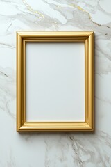 A gold framed white picture is on a marble counter