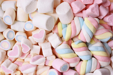 Confectionery and sweeties varieties background: light pink and white marshmallows, sugar confetti, bonbon and candies, selective focus, shallow focus
