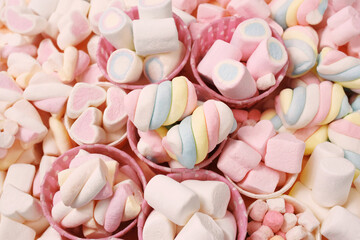 Confectionery and sweeties varieties background: light pink and white marshmallows, sugar confetti, bonbon and candies, selective focus, shallow focus