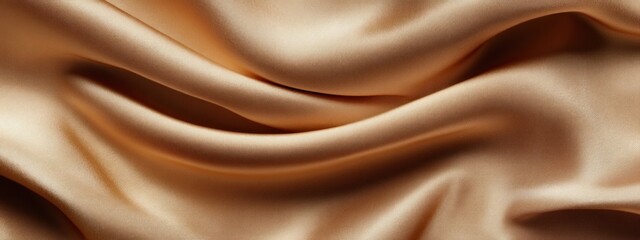 Obraz premium Close-up of draped beige satin fabric, showing soft folds and luxurious texture.