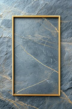 A gold frame is on a gray stone wall
