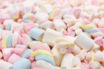 Confectionery and sweeties varieties background: light pink and white marshmallows, sugar confetti, bonbon and candies, selective focus, shallow focus