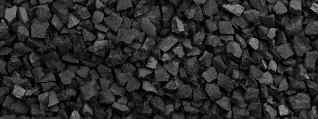 Close-up of dark gray, rough, irregular shaped stones.