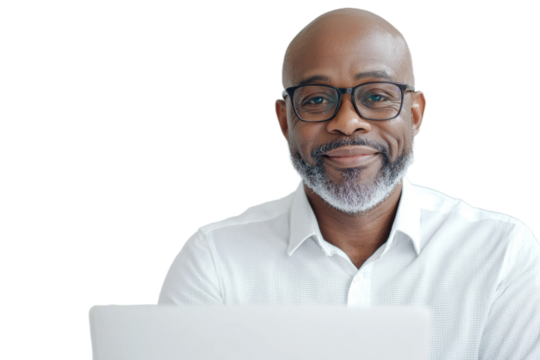 A man wearing glasses is sitting in front of a laptop