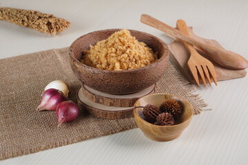 "Abon Ikan" is a typical food from Indonesia. namely a type of floss made from catfish meat, in a wooden bowl photographed in the studio with a wooden theme prop