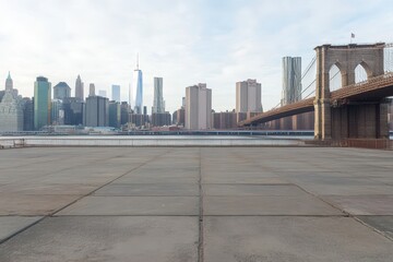 Empty urban plaza with NYC skyline & Brooklyn Bridge.