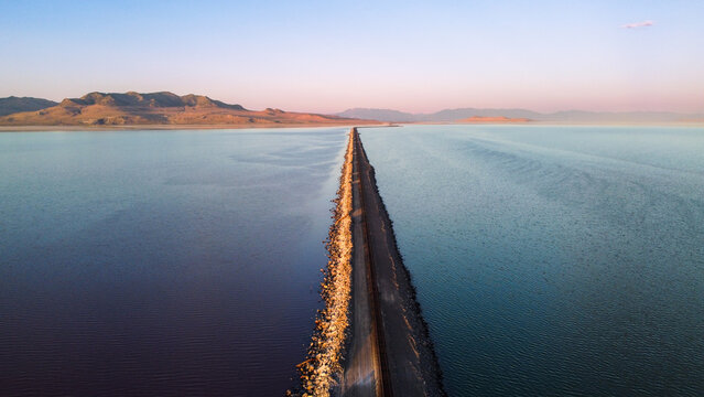Aerial Views of the Great Salt Lake Lucin Cutoff Divide Pink Water Contrast with Single Railroad Track Causeway 