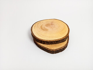 round flat wood pieces, circular wood grain texture visible on a white background