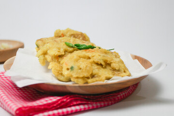 Tempe Mendoan, or fried tempeh with flour isolated on white background. Tempe Mendoan is a popular street food from Indonesia.