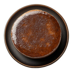 Extreme top view of extremely perfect looking Jujube Paste Cake on a dark crockery, isolated on a white transparent background