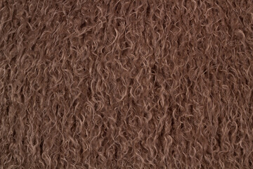 Fabric Texture Background: A close-up shot highlighting the soft texture and brown color of faux fur textile, perfect for fashion or decor.