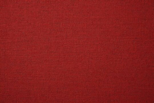 a close up of a red fabric textured background with a slight pattern