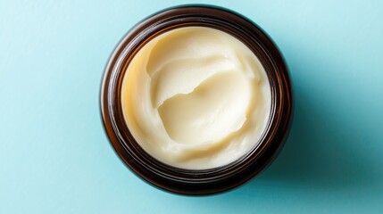 Creamy Moisturizer in Amber Jar on Soft Blue Background