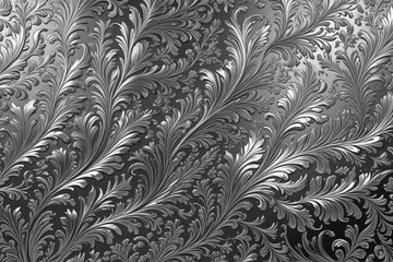 a close up of a metal surface with a pattern of swirly leaves