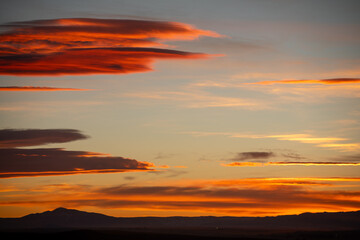 Orange sunset in the mountains with clouds