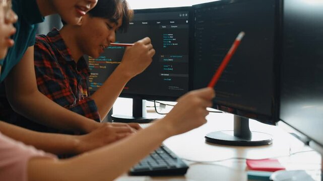 Slow motion back end software developer engineer for computer programming working together on debugging writing computing code, solving complex algorithms display on monitor in office. Burgeoning