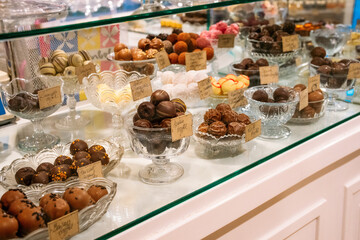 Showcase of Truffles and Chocolates Elegantly Displayed on Glass Plates