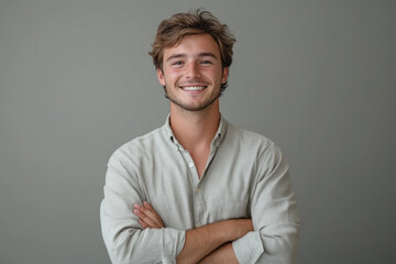 Smiling man with arms crossed.