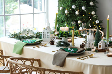 Festive table setting in living room with Christmas tree