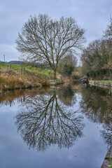 moored narrow canal boats on river Dee near the Pontcysyllte Aqueduct in Wales.