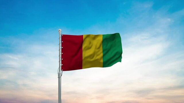 Guinea flag on a flagpole waving in the wind