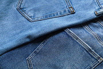 Naklejka premium Set of stylish blue jeans as background, closeup