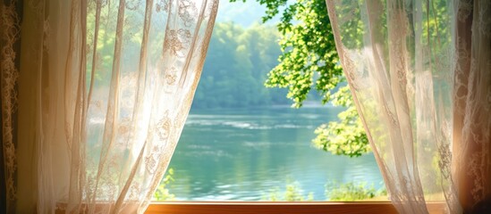 Lace curtains fluttering in the breeze reveal a serene river view surrounded by lush greenery and...