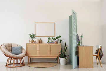 Interior of living room with folding screen and workplace