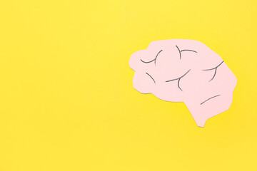 Paper human brain on yellow background