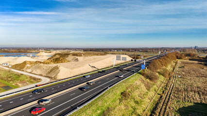 Industrial landscape with highway and cars traffic aerial drone view from above, modern motorway...