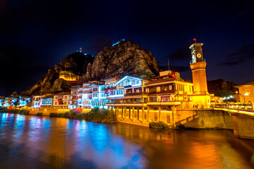 Old Ottoman houses evening colorful lights view by the Yesilirmak River in Amasya City. Amasya is populer tourist destination in anatolia Turkey. Amasya City, Turkey
