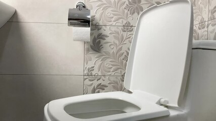 A woman's hand throws a lot of toilet paper into the toilet.