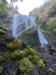 Khlonglan waterfall with moss in rainforest