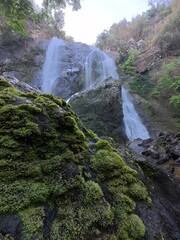 Khlonglan waterfall with moss in rainforest