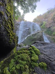 Khlonglan waterfall with moss in rainforest