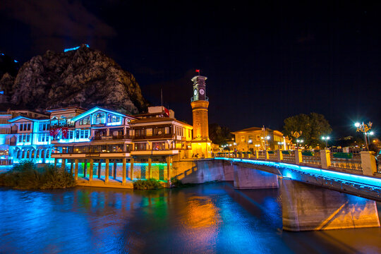 Old Ottoman houses and Clock Tower with night and mirrored view by the Yesilirmak River in Amasya.Amasya is populer tourist destination in Turkey.