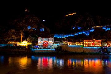 Old Ottoman houses and Clock Tower with night and mirrored view by the Yesilirmak River in Amasya. Amasya is populer tourist destination in Turkey.