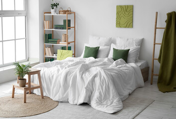 Cozy bed, bookcase and ladder with green plaid in interior of bedroom