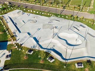 Aerial view of a vibrant skate park, complete with ramps and obstacles, nestled within a park....