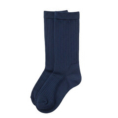 Stylish action of wearing blue socks indoor setting product photography cozy environment close-up...