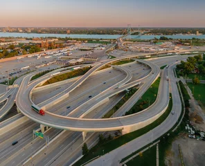 Aerial view of complex highway interchange, border crossing, and city.  US CUSTOMS AND BORDER PROTECTION - INSPECTION FACILITY, DETROIT, MICHIGAN, UNITED STATES