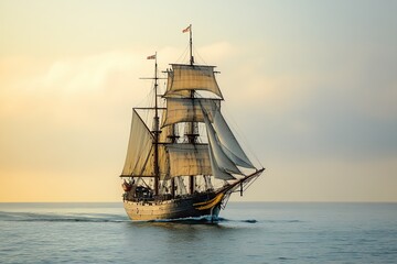 Obraz premium Sailing ship navigating calm waters at sunset.